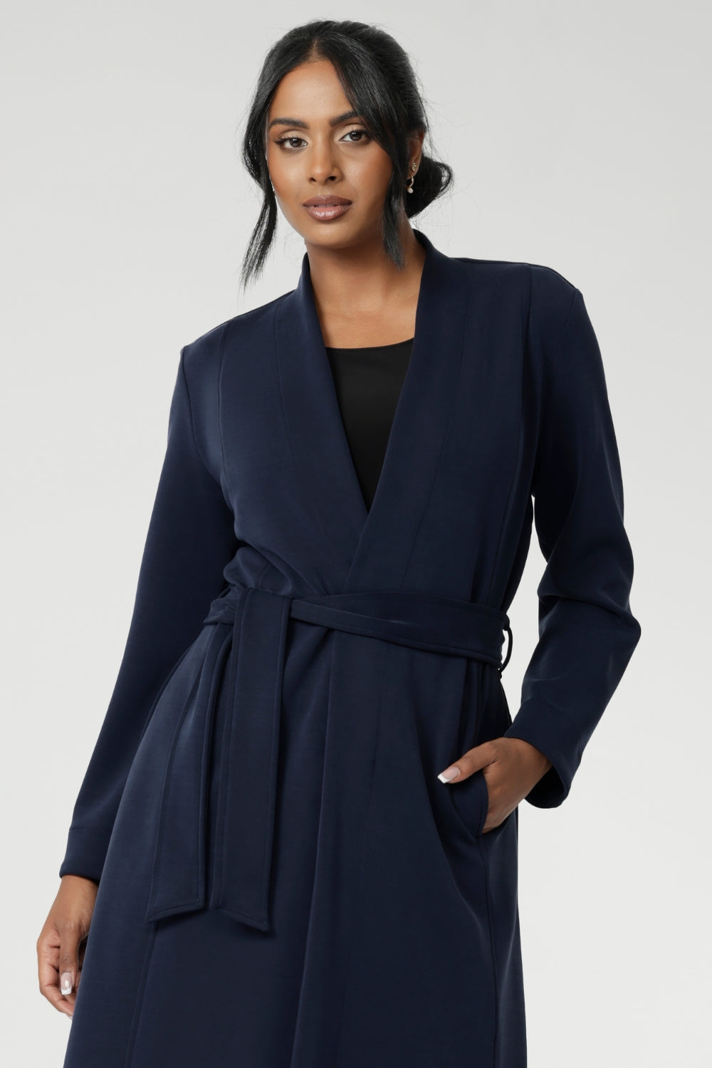 Crafted from a luxurious winter-weight Modal fabric, it combines soft structure and stretch, making it the perfect travel companion for those seeking both style and comfort. Size 10 model wears Sorel Trenchcoat in Midnight over black top.