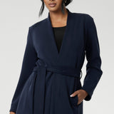 Crafted from a luxurious winter-weight Modal fabric, it combines soft structure and stretch, making it the perfect travel companion for those seeking both style and comfort. Size 10 model wears Sorel Trenchcoat in Midnight over black top.