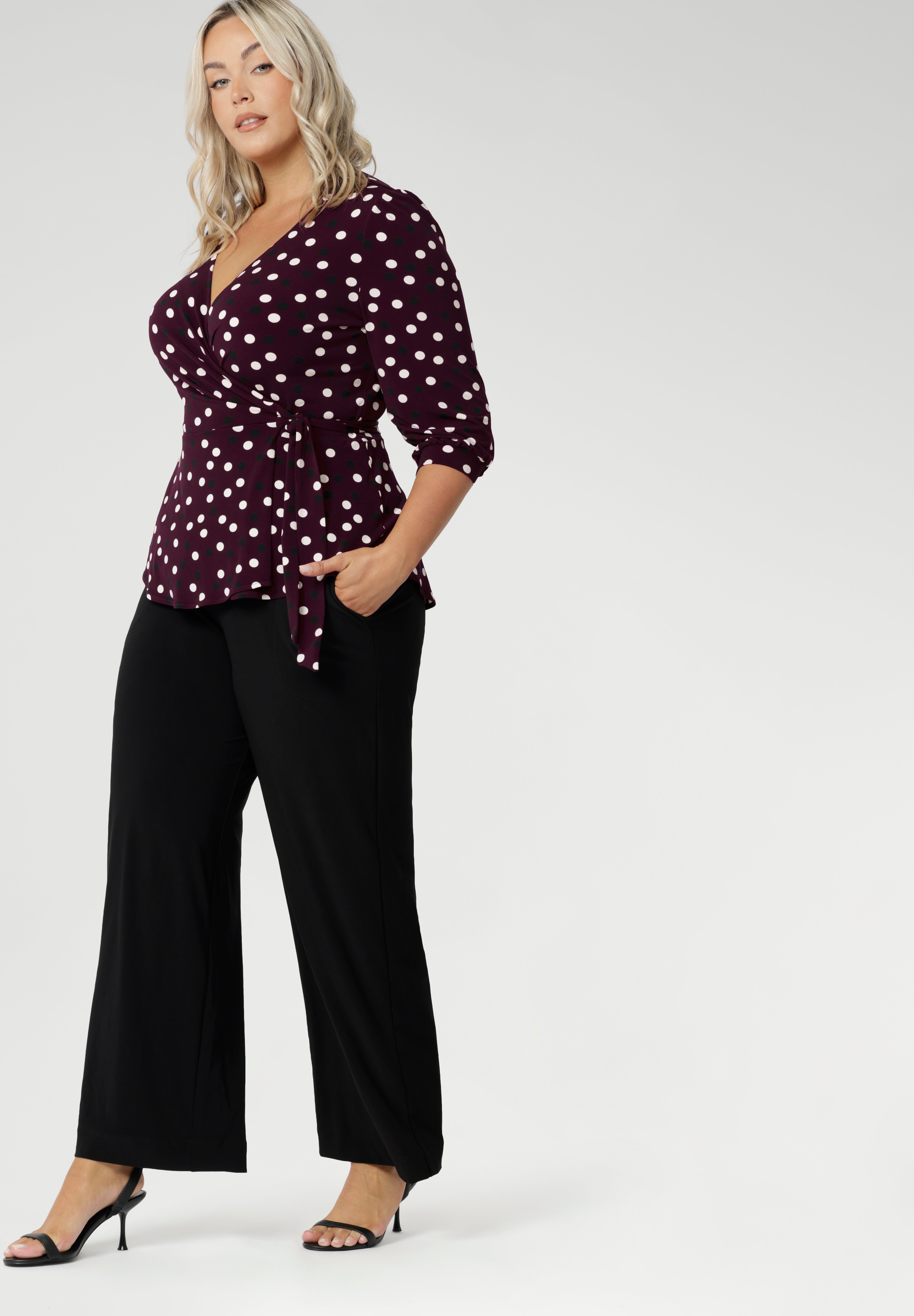 The Tristan wrap top is thoughtfully designed for both comfort and style. Featuring a flattering peplum silhouette, its hemline dips gracefully at the back, offering extra coverage and a feminine touch. The elbow-length bishop sleeves add a hint of volume while maintaining ease of movement, providing coverage through the arms without feeling restrictive.