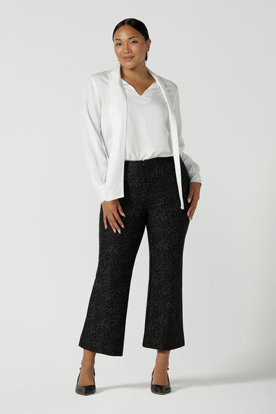 Stylish woman wears Grey Leopard printed Ponte Troy Pants. A kick flare pant in a fashionable on trend leopard print paired back with a Matisse shirt in white. Made in Australia for women size 8 - 24.