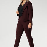 Plus size woman wears the Vida top in black that has a V-neckline and 3/4 sleeve with burgundy suiting set, with matching pants and jacket. Comfortable dry touch jersey top for corporate workwear to weekend wear. Made in Australia for women sizes 8-24.
