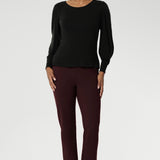 The boat neckline frames the collarbone with subtle sophistication, while tailored bust darts and a close-to-body shape enhance the fit without feeling restrictive. Crafted with attention to detail, the full-length sleeves feature gentle gathers at the shoulder and a wrist dart, adding soft volume and movement—ideal for styling under outerwear without bulk.