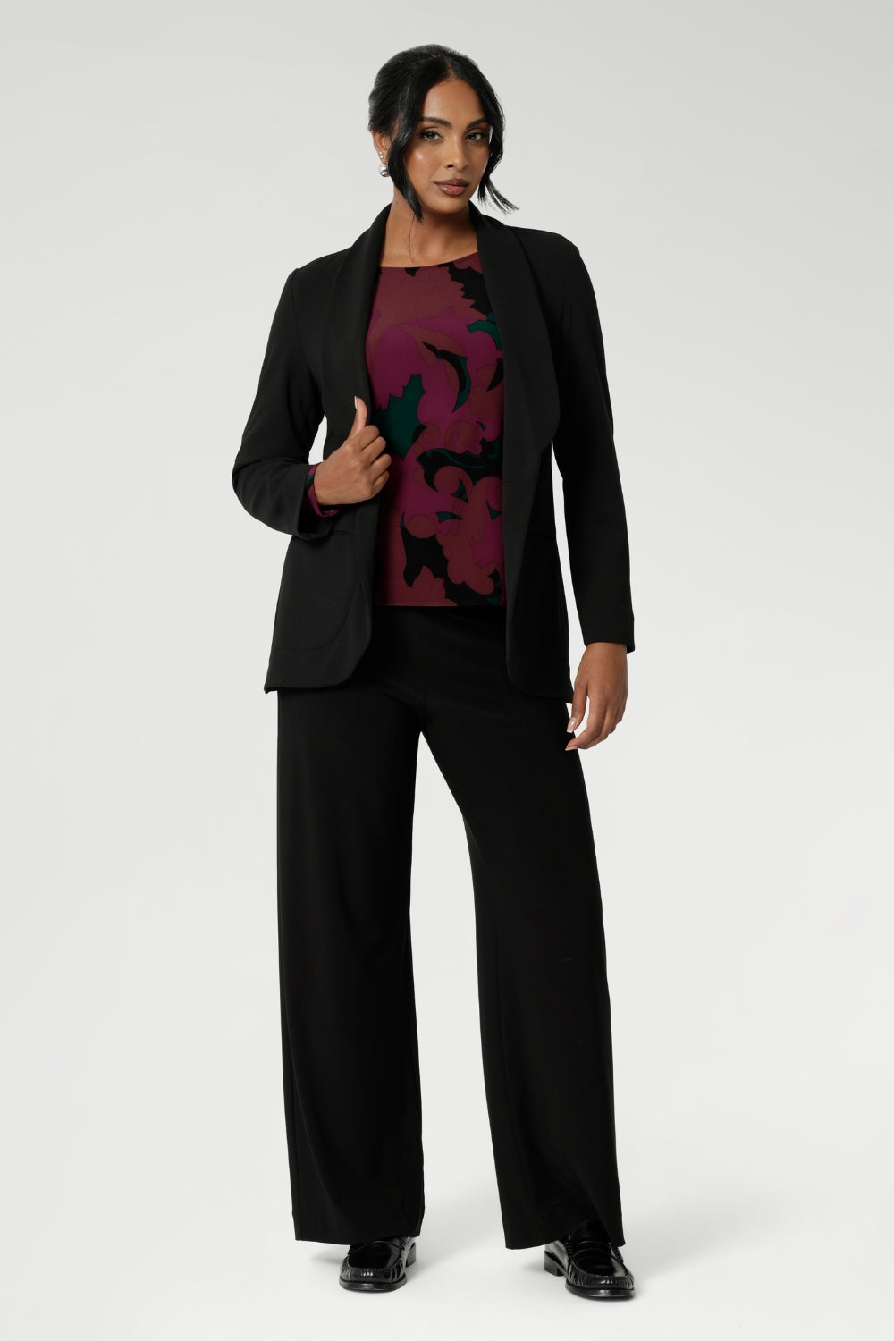 Zara is a modern-cut top with bellow sleeves and a subtle shape through the body—an effortless choice for transitioning from work to weekend. Pairs perfectly with our soft suiting collection. Size 10 model wears her printed workwear top with black easy care blazer and matching black pants.