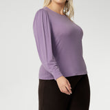 Flattering boat neckline and full-length bellow sleeves with delicate gathers at the shoulders and refined darts at the wrists, creating subtle volume that layers beautifully under coats and jackets. The tailored bust darts and close-to-body silhouette offer a sleek yet relaxed fit.