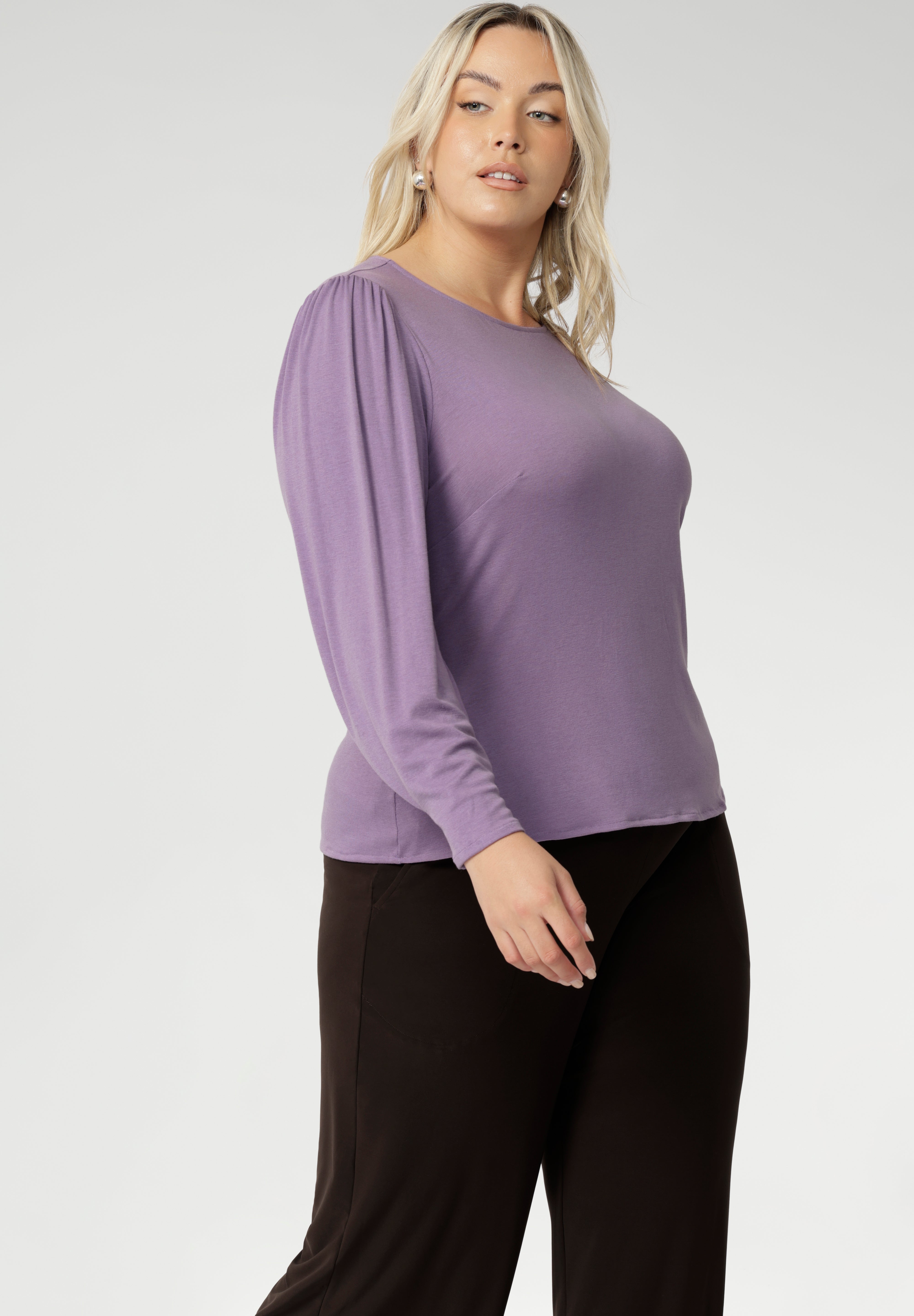 Flattering boat neckline and full-length bellow sleeves with delicate gathers at the shoulders and refined darts at the wrists, creating subtle volume that layers beautifully under coats and jackets. The tailored bust darts and close-to-body silhouette offer a sleek yet relaxed fit.