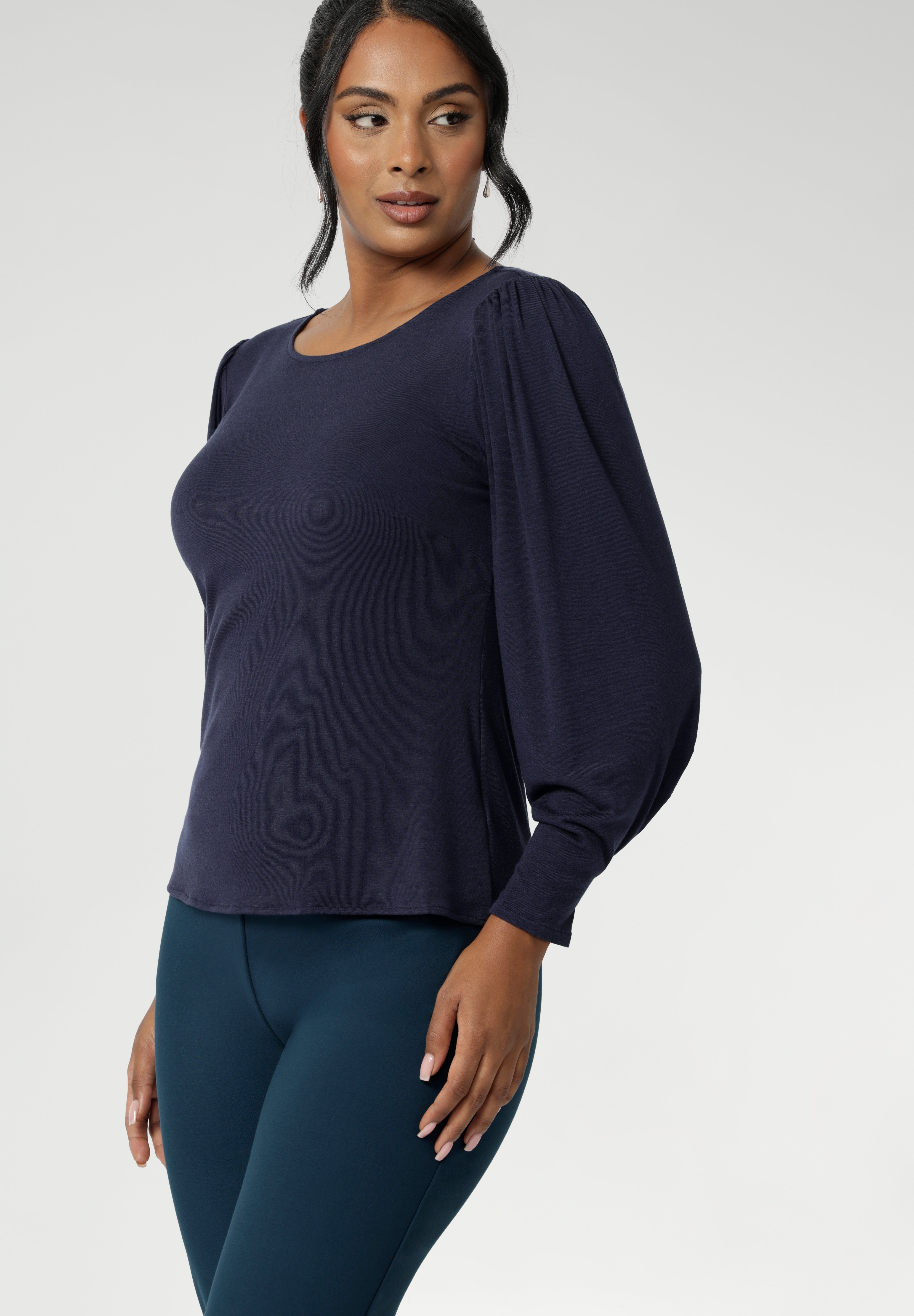 Zara is the ultimate knit top for effortless layering through the cooler months. Designed with a modern, feminine cut, it features a boat neckline and full-length bellow sleeves with soft gathers at the shoulders and tailored darts at the wrists—adding gentle volume without the bulk. Subtle shaping through the body and bust darts create a flattering, close-to-body fit that moves easily from work to weekend