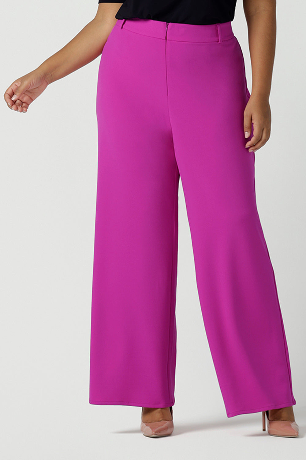 Close up of a size 16 Woman wears the Drew Pant in Fuchsia. A high waist tailored pant with matching suit blazer. Made in Australia for women size 8 - 24.