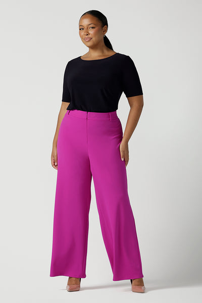 Size 16 Woman wears the Drew Pant in Fuchsia. A high waist tailored pant with matching suit blazer. Made in Australia for women size 8 - 24. 