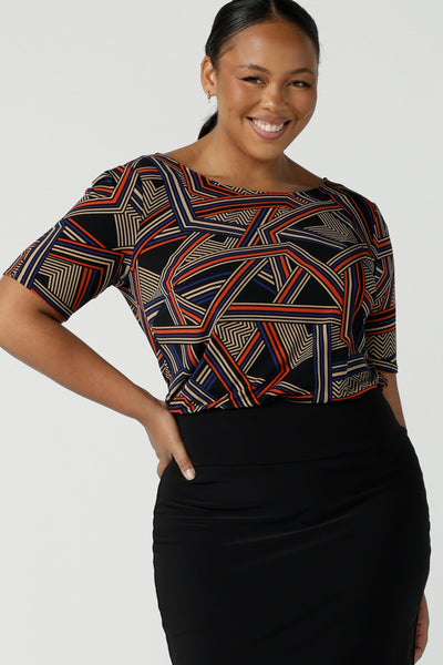 Size 16 woman wears the Ziggy Top in Trixe, a jersey boat neckline top and short sleeves. Conservative boat neckline and softly curved hem. Easy care jersey and size inclusive for petite to plus size. Made in Australia for women size 8 - 24.