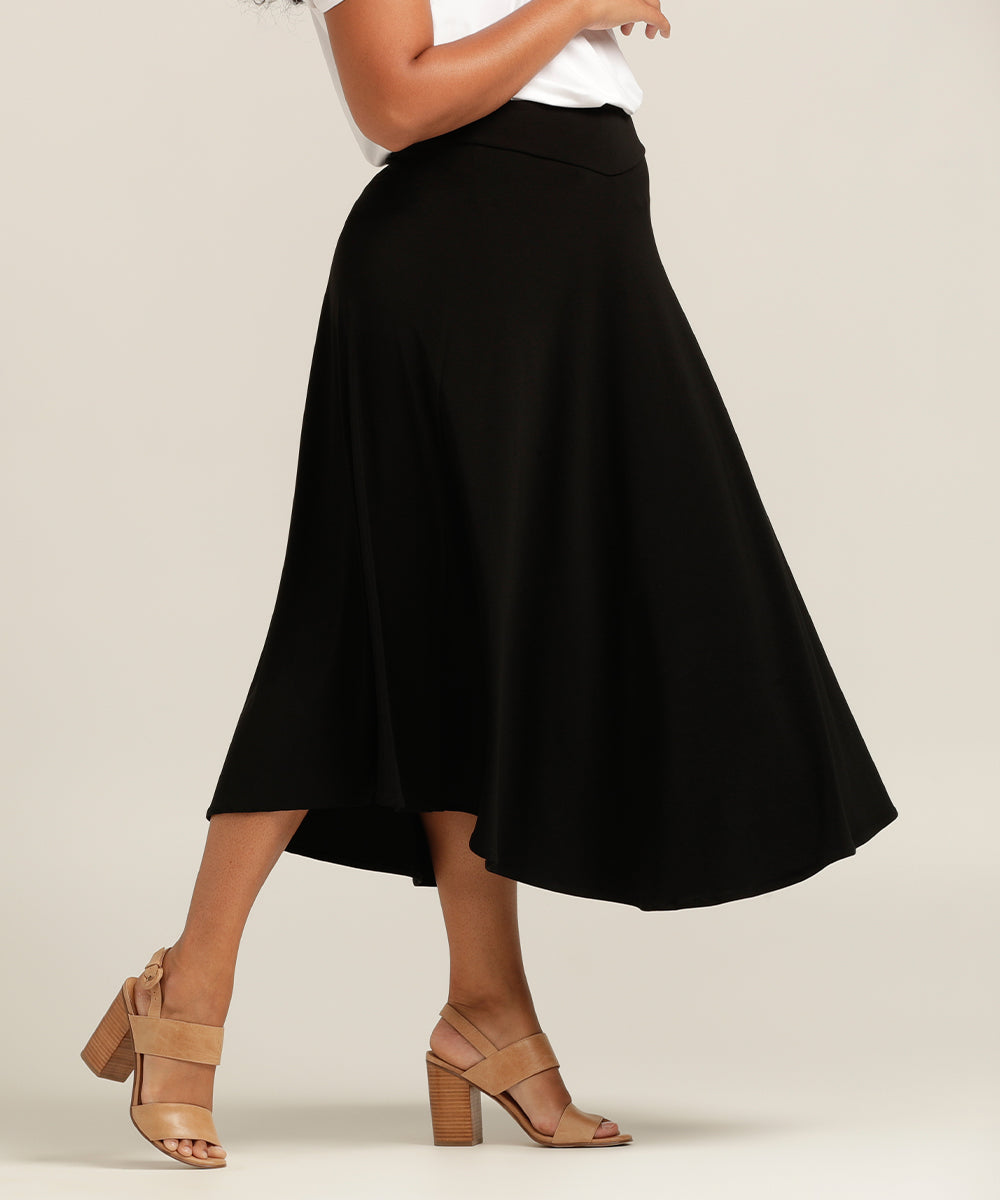 designer women's skirts made in Australia - free shipping to New Zealand may 2023 - model wears black flowy skirt as a sophisticated work skirt or our to dinner 