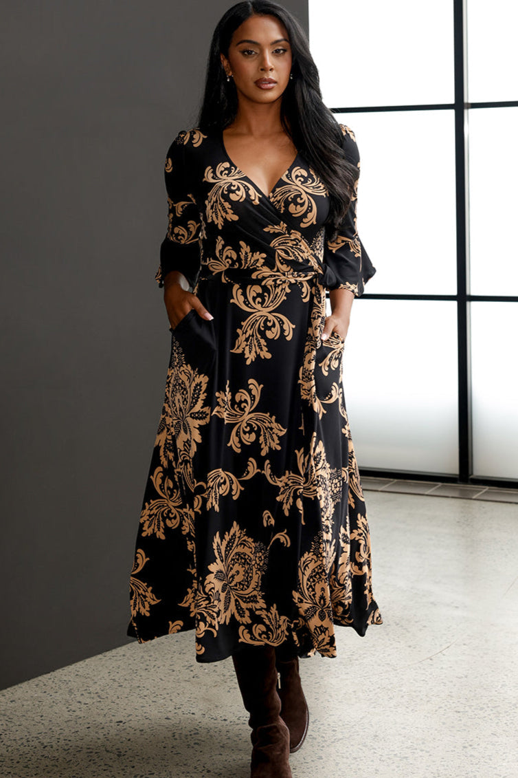 Size 10 woman wears the Portia Dress with brown knee-high boots.. 