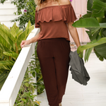 Off duty pants for tall women, these tapered leg, long length pants by Australian and New Zealand women's  clothing brand, Leina & Fleur are comfortable stretchy pants in espresso brown slinky jersey fabric. Worn with an off the shoulder clay coloured top. These are easy care tall pants for summer styling. Shop travel pants for plus size women and ladies tall pants online in sizes 8 to 24. 