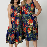 Full body image of two woman of different heights wearing the Darci Knee Length Dress in Bahagia. Floral halter dress is stocked in petite and plus sizes. This resort ready dress is made from slinky jersey fabric.This resort style dress is perfect for travel as the fabric is wrinkle resistant. Leina & Fleur is a woman's brand that stock sizes from 8 to 24.