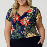 Plus sized model wears floral top with cowl neck detail. Top for summer has been crafted with breathable fabric. Easy-care and crease-resistant top is perfect for travel. Leina & Fleur is a womans clothing brand that have sizes from 8-24. Shop this summer ready top in petite sizes and plus sizes. Lightweight and packable, fits easily in your suitcase for your travel adventures. 