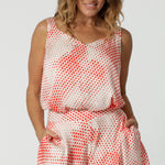 Showing cami top for over 40s women, this silky cami top with wide shoulder straps has an orange spot print. Made in Australia by women's clothes brand, Leina & Fleur, wear this lightweight cami top is breathable top for summer wear. Shop this summer top for women  online in sizes 8 to 24.