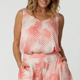 Showing cami top for over 40s women, this silky cami top with wide shoulder straps has an orange spot print. Made in Australia by women's clothes brand, Leina & Fleur, wear this lightweight cami top is breathable top for summer wear. Shop this summer top for women  online in sizes 8 to 24.