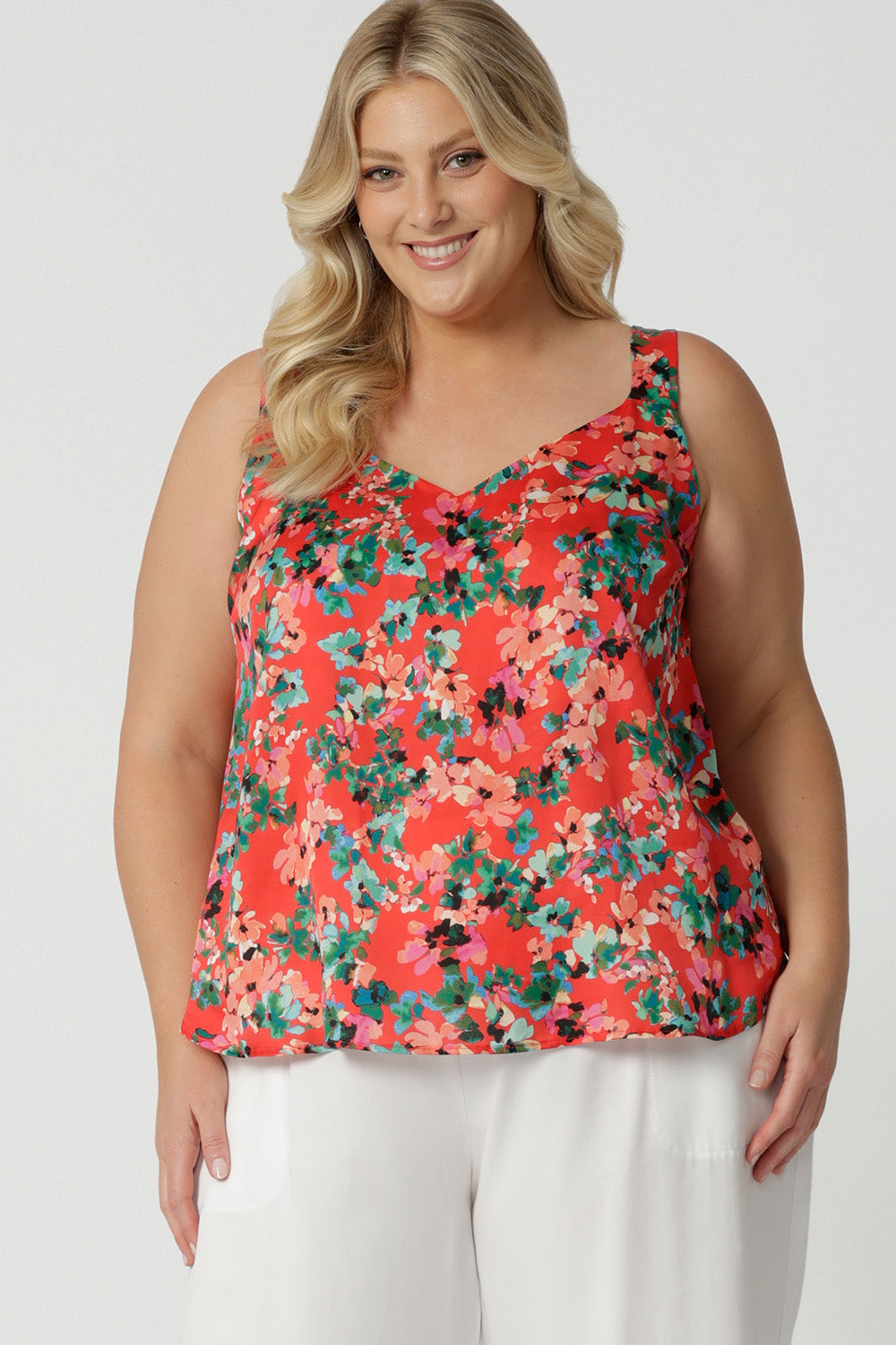 Showing cami top for plus size women, this silky cami top with wide shoulder straps has a floral print on tangerine Italian Viscose fabric. Made in Australia by women's clothes brand, Leina & Fleur, wear this lightweight plus size cami top is breathable top for summer wear. Shop this summer top for women  online in sizes 8 to 24.