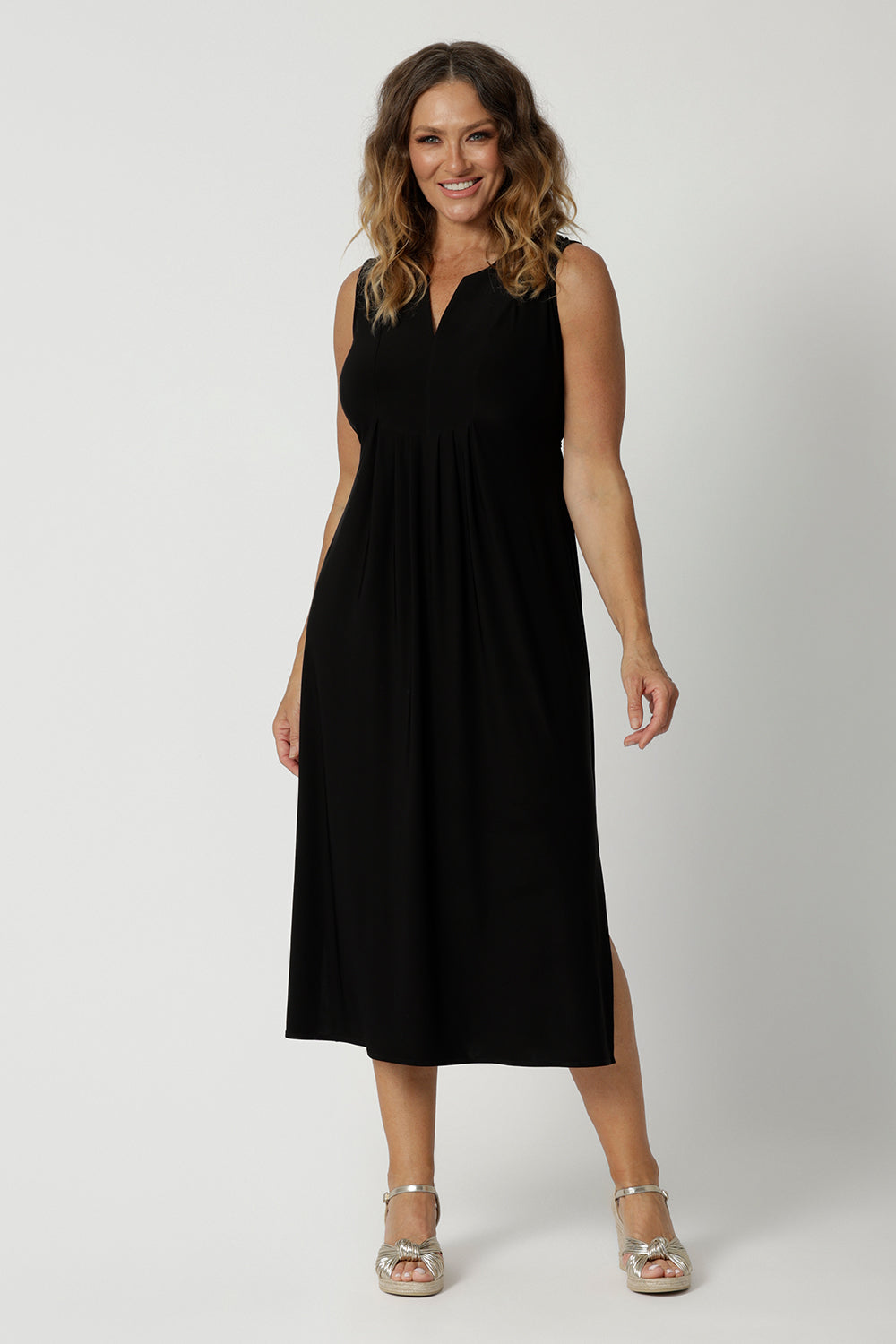 Back view of a women's empire line black jersey dress  Shown on a dress size 12, this sleeveless black dress is made in Australia by Australian and New Zealand women's clothing brand, L&F. Shop event wear black dress Australia online in size 8 to 24.