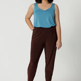 Good travel pants for petite women. These tapered leg pants by Australian and New Zealand women's  clothes brand, Leina & Fleur are comfortable stretchy pant in espresso brown jersey fabric. Shop pants for petite height women online in sizes 8 to 24.