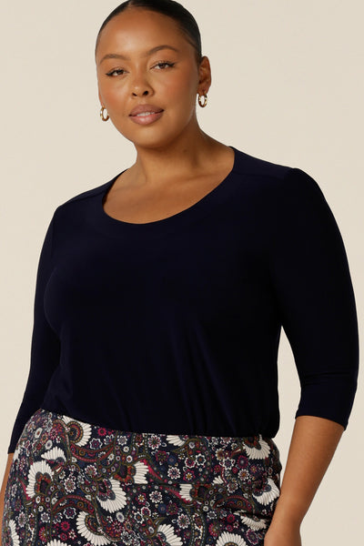 A 3/4 sleeve, round neck top in navy blue is ownr by a size 18, plus size woman. Made in Australia by Australian and New Zealand women's clothing brand, L&F, this slim fit top in stretch jersey fabric is a comfortable top for work wear or casual wear.
