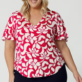 This summer top is the perfect blend of comfort and style, featuring delicate flutter sleeves that add a touch of femininity and movement. The top comes in a sophisticated red base with a striking ivory floral design. Crafted from high-quality dry-touch jersey, the fabric offers a soft, breathable feel that’s ideal for warmer weather, keeping you cool and comfortable throughout the day. Shop the Lila Top in sizes 8-24.