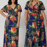 Two women of different heights wearing maxi dress. Long wrap dress is stocked in petite and plus sizes. This resort ready dress is made from slinky jersey floral fabric. Resort style dress perfect for travel as the fabric is wrinkle resistant. Leina & Fleur stock sizes from 8 to 24.