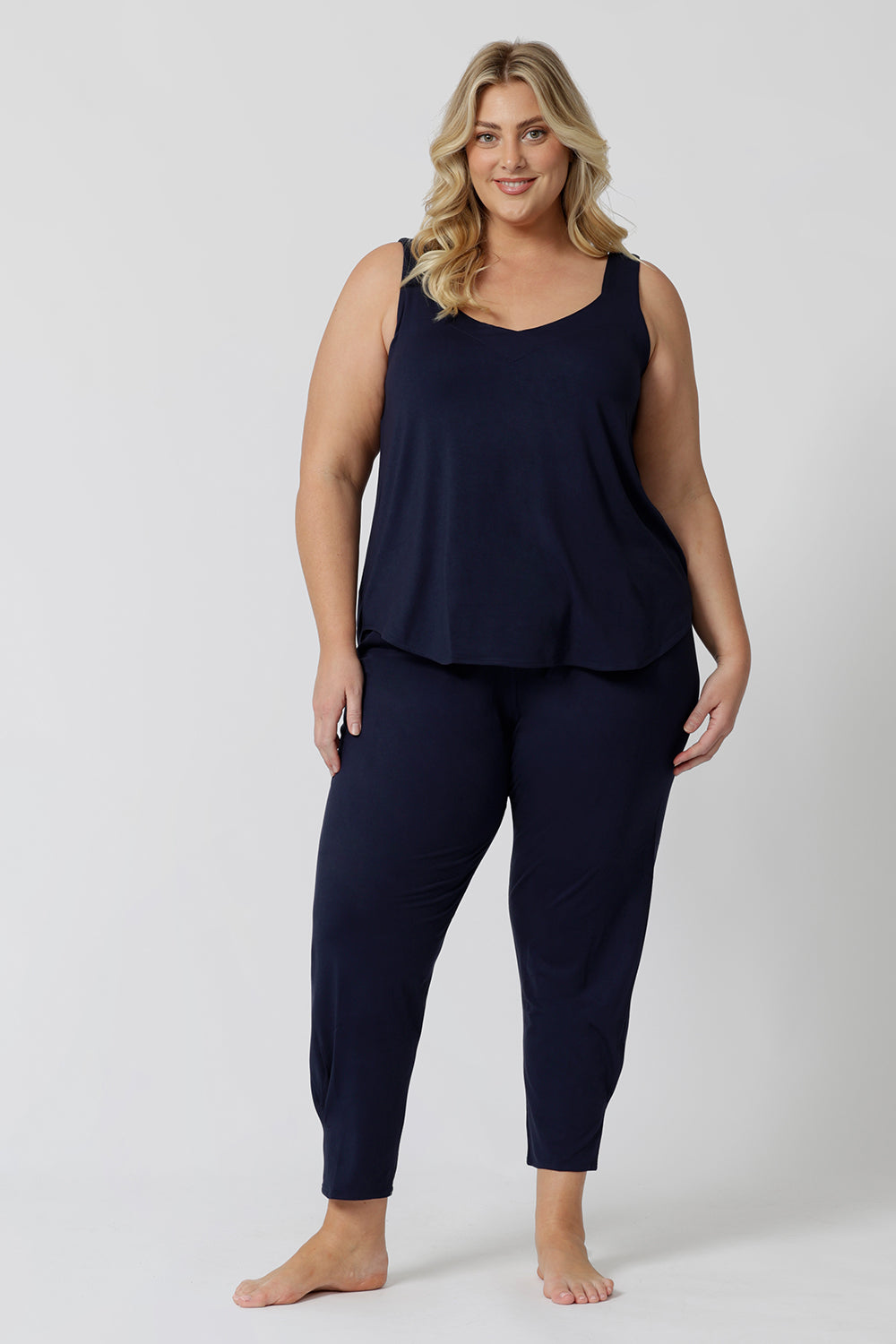 A good loungewear pant for curvy women, this navy bamboo tapered leg,  plus size pant is a pull-on pyjama pant. Worn with black bamboo cami top, this is a breathable, thermo-regulating pyjama set and makes get sleepwear for night sweats and hot flushes. Shop loungewear sets online at L&F Australia.