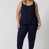 A good loungewear pant for curvy women, this navy bamboo tapered leg,  plus size pant is a pull-on pyjama pant. Worn with black bamboo cami top, this is a breathable, thermo-regulating pyjama set and makes get sleepwear for night sweats and hot flushes. Shop loungewear sets online at L&F Australia.