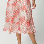 Close up view of orange-red spot print  culottes for women in luxurious Italian viscose fabric. These summer culottes are made in Australia by Australian and New Zealand women's clothing brand, Leina & Fleur, shop this summer wedding guest and event wear outfit online in sizes 8 to 24.