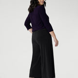 Petite height women wears the short length culottes, paired with amethyst V-neck top and brown kitten heels. The Bradley Culottes in Charcoal come  different leg lengths and are available in sizes 8-24.