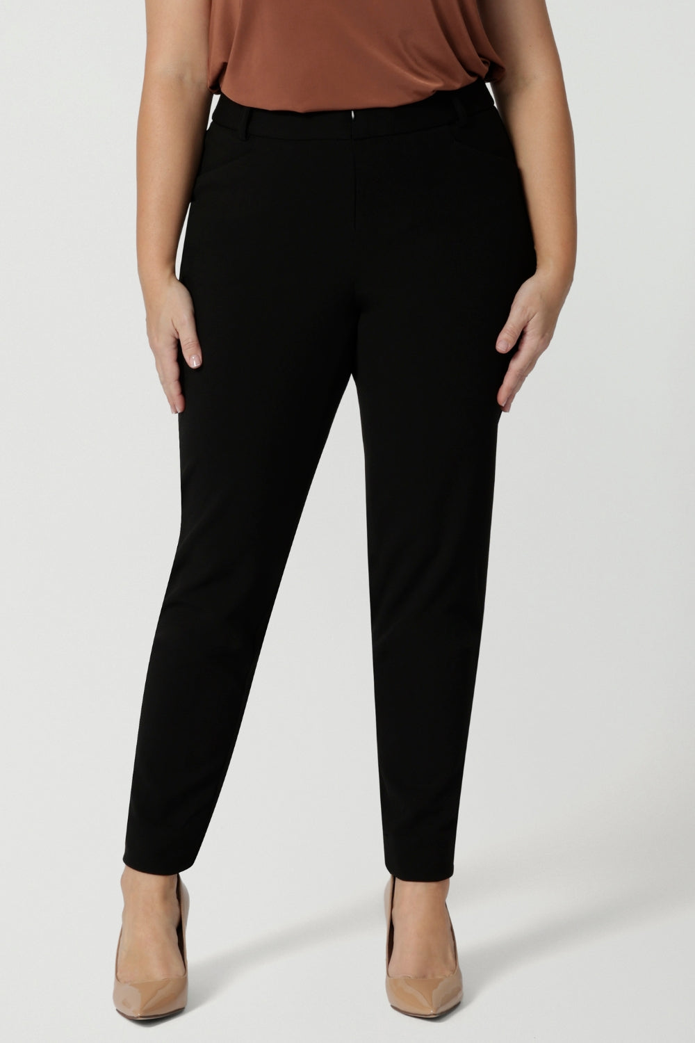 Close up image of pants worn by plus sized model. Easy care pants are made from scuba crepe fabric that provide comfortability and stretch when worn. Image shows pants styled with blazer for a full suiting look. Woman's clothing brand Leina & Fleur is Australian made and have a size offering of 8-24.