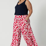 Wide-leg silhouette offers a flattering, relaxed fit that flows effortlessly, making them perfect summer season. Palazzo pants feature a bold red base adorned with a stunning ivory floral design.  Crafted from high-quality dry-touch jersey fabric. The lightweight fabric ensures you stay cool and comfortable while maintaining a polished appearance. Caspian Palazzo Pant is stocked in sizes 8-24.