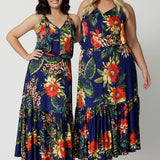 Full body image of 2 woman of different heights wearing the Darci Dress in Bahagia. Floral halter dress is stocked in petite and plus sizes. This easy care dress is made from slinky jersey fabric.This resort style dress is perfect for travel as the fabric is wrinkle free. Leina & Fleur is a woman's brand that stock sizes from 8 to 24.