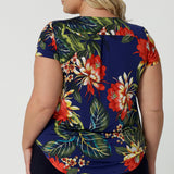 Back view image of plus sized model wearing floral top. Easy care top is made of slinky jersey that is crease-resistant perfect for travel. Comfortable fir top is flattering and relaxed for all-day travel wear. Leina & Fleur stock sizes 8-24. 