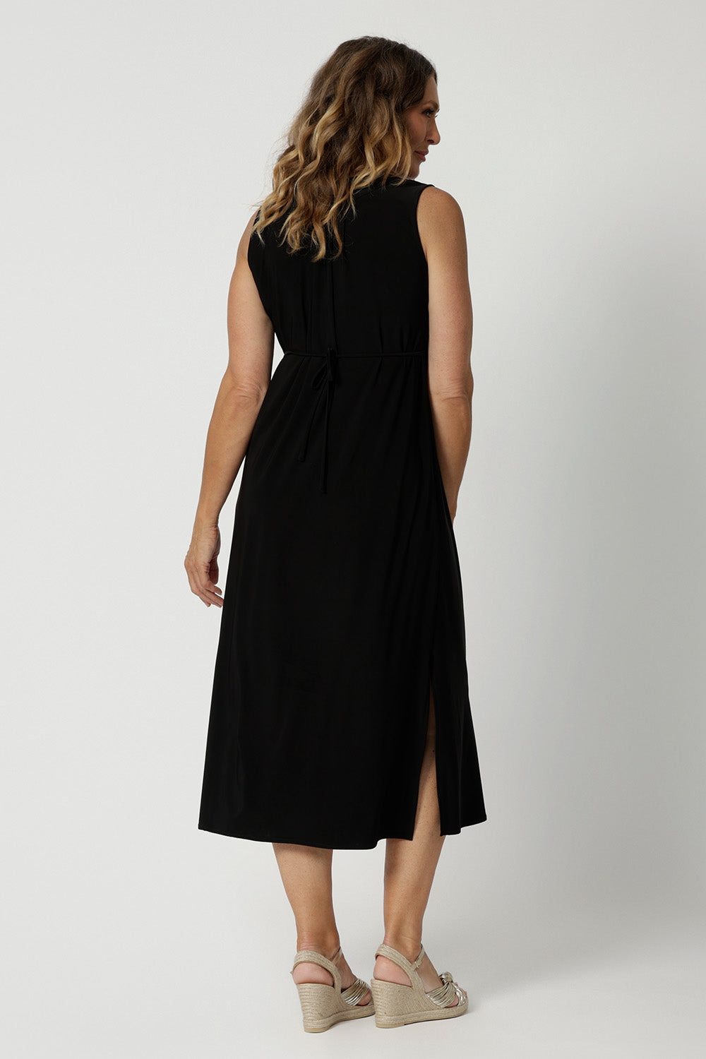 Back view of a an empire line black jersey dress  Shown on a size 18, this sleeveless black dress is made in Australia by Australian and New Zealand women's fashion brand, L&F. Shop plus size summer dresses Australia online in size 8 to 24.