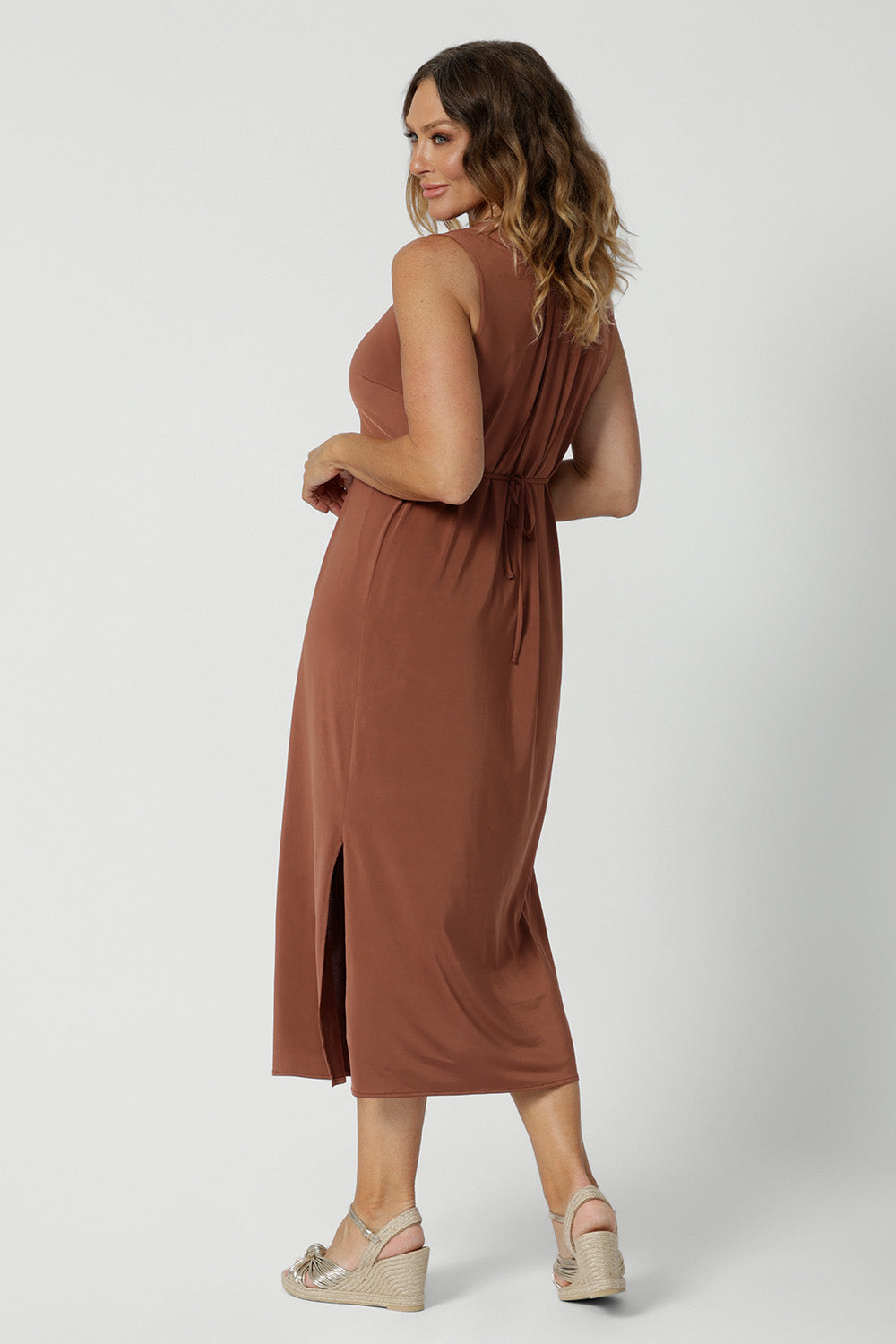 Back view of a dress for over 40s women, this sleeveless clay coloured dress in slinky jersey fabric is perfect as an off duty summer dress. Made in Australia by Australian and New Zealand women's clothes label Leina & Fleur. This midi-length empire line dress is available in sizes 8 to 24.