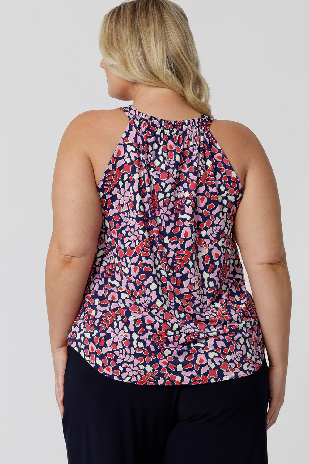 Back view of  a summer top for over plus size women. This halter neck top is a comfortable, easy-care top worn with white pants for summer.  In red, pink, white and navy print, this plus size jersey top is a made in Australia top by Australian and New Zealand women's clothes brand, Leina & Fleur, shop their petite to plus size tops online. 