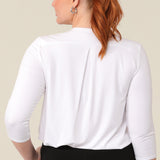 Back view of a great top for curvy women. This white bamboo jersey top is tailored with a pleat below the V-neck and at the back shoulder yoke. Lightweight and breathable, this 3/4 sleeve top makes a comfortable work top, looking classic under workwear jackets and suits. A classic top, this white jersey top is good for casual wear and travel capsule wardrobes too. shown on a curvy, mid size woman, this top is also available in petite and plus sizes online at women's clothing brand, Leina & Fleur. 