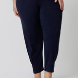 Close up of a good loungewear pant for curvy women. This navy bamboo tapered leg,  plus size pant is a pull-on pyjama pant. Worn with navy bamboo cami top, this is a breathable, thermo-regulating pyjama set and makes get sleepwear for night sweats and hot flushes. Shop loungewear and sleepwear sets online at L&F Australia.