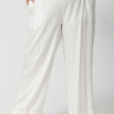 Close up image of a curvy, size 18 woman wearing pull-on, easy care style pants. Resort ready style is comfortable and breathable for everyday wear. Shop these wide leg pants online in sizes 8 to 24. Lyocell fabric designed pants are petite and plus size friendly.