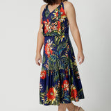 A midi floral dress for cruise holidays and resort style perfect for summer Easy care slinky jersey dress worn by petite woman shows length of dress.  This floral jersey fabric is easy-care and crease-resistant. Australian made for Australian and New Zealand women. Fashion brand Leina & Fleur stock sizes in sizes 8 to 24. Shop easy travel pieces online.