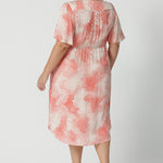 Back view of a good dress for plus size women, this silky flutter sleeve dress in viscose fabric has an orange spot print. Made in Australia by women's clothing brand, Leina & Fleur, this lightweight summer dress is breathable. Shop this summer wedding guest and event wear outfit online in sizes 8 to 24.