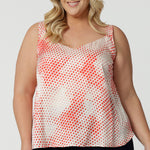 Showing cami top for plus size women, this silky cami top with wide shoulder straps has an orange spot print. Made in Australia by women's clothing brand, Leina & Fleur, wear this lightweight cami top is breathable top for summer wear. Shop this summer top for women  online in sizes 8 to 24.
