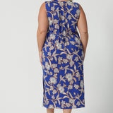 Back view of sleeveless floral print dress in slinky jersey fabric, perfect for off-duty summer styling. Made in Australia by Australian and New Zealand women's clothing brand, Leina & Fleur. This plus size midi-length empire line dress is available in sizes 8 to 24.