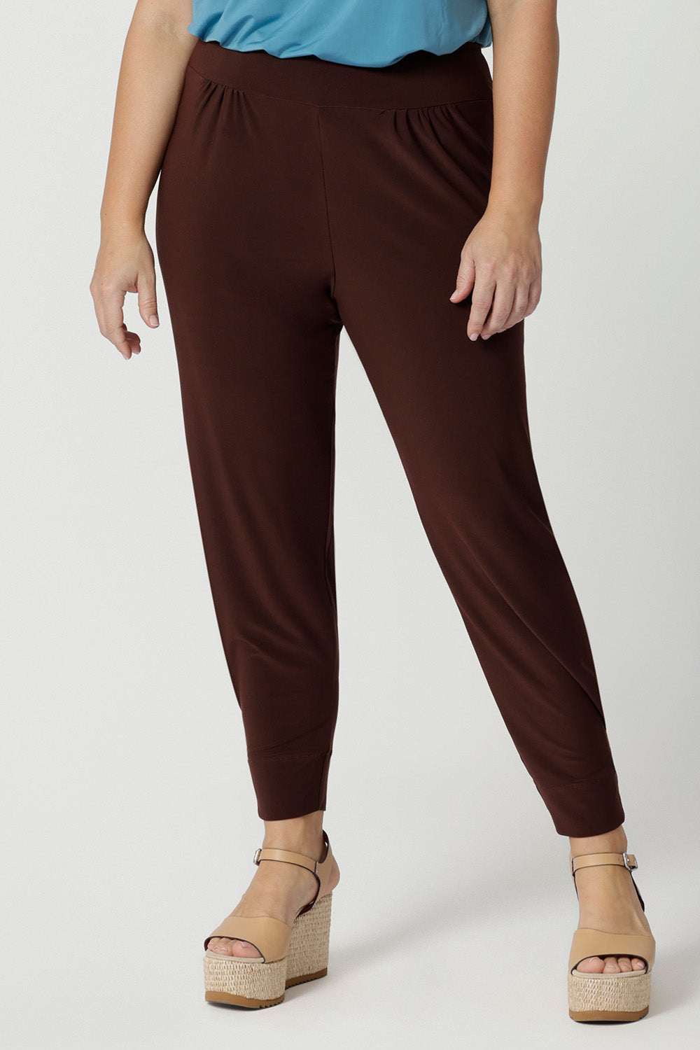 Close up of goof off duty pants for petite women. These tapered leg pants by Australian and New Zealand women's  clothes brand, Leina & Fleur are comfortable, stretchy pants in espresso brown jersey fabric. Shop pants for petite height women online in sizes 8 to 24.