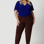 Off duty pants for tall, plus size women, these tapered leg, long length pants by Australian and New Zealand women's  clothing brand, Leina & Fleur are comfortable stretchy pants in espresso brown jersey fabric. Shop travel pants for plus size women and ladies tall pants online in sizes 8 to 24.