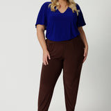 Off duty pants for tall, plus size women, these tapered leg, long length pants by Australian and New Zealand women's  clothing brand, Leina & Fleur are comfortable stretchy pants in espresso brown jersey fabric. Shop travel pants for plus size women and ladies tall pants online in sizes 8 to 24.