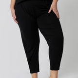 Close up of a good loungewear pant for curvy women. These black tapered, plus size pants are pull-on pyjama pants. Worn with black bamboo cami top, this is a breathable, thermo-regulating pyjama set and makes get sleepwear for night sweats and hot flushes. Shop loungewear sets online at L&F Australia.