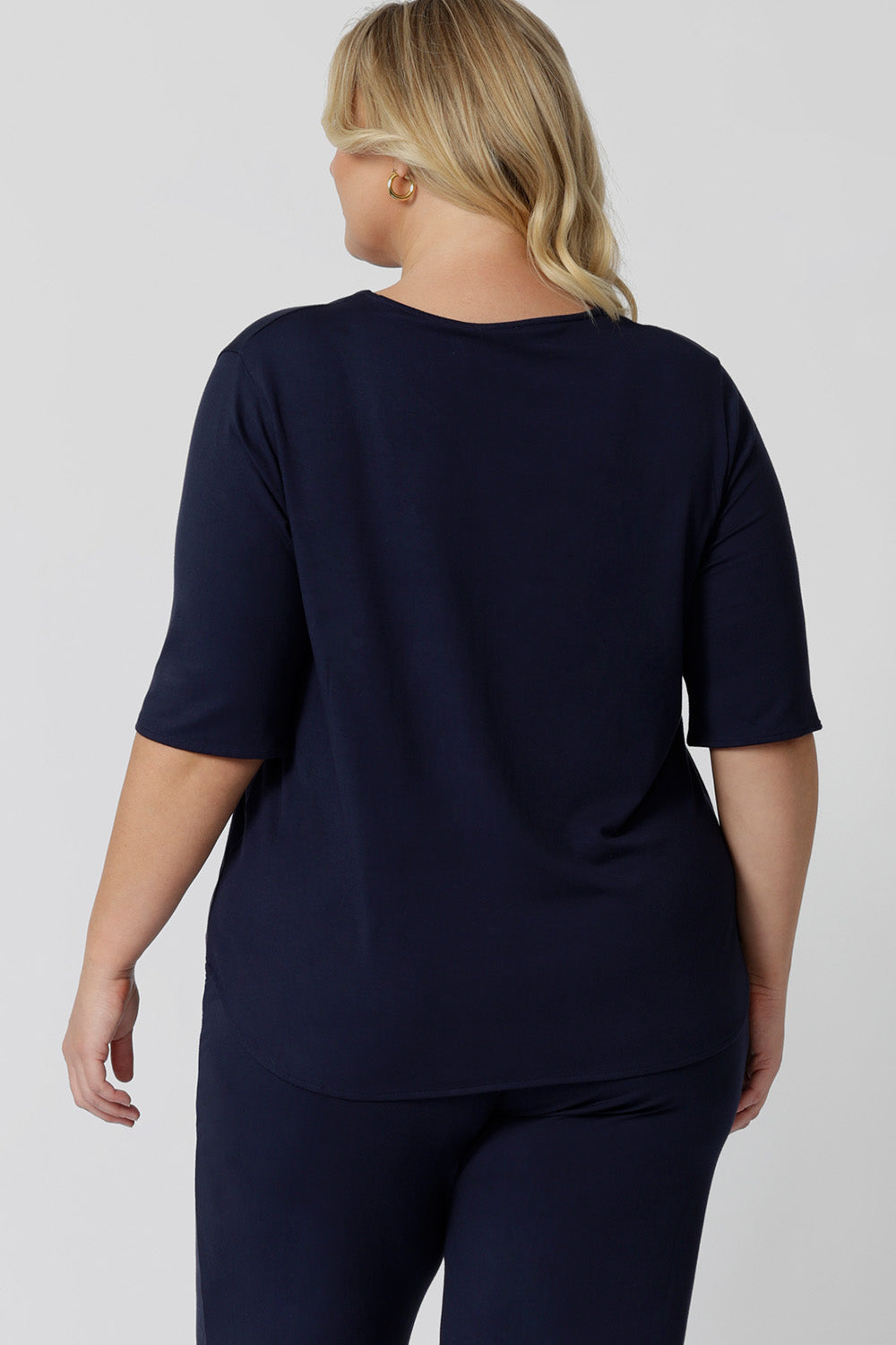 Back view of a 3/4 sleeve, navy blue tee top. A great top for plus size sleepwear, it's worn by a size 18 woman, this curve top makes for a comfortable pyjama top and being breathable and thermo-regulating, it's a great top for night sweats and hot flushes.