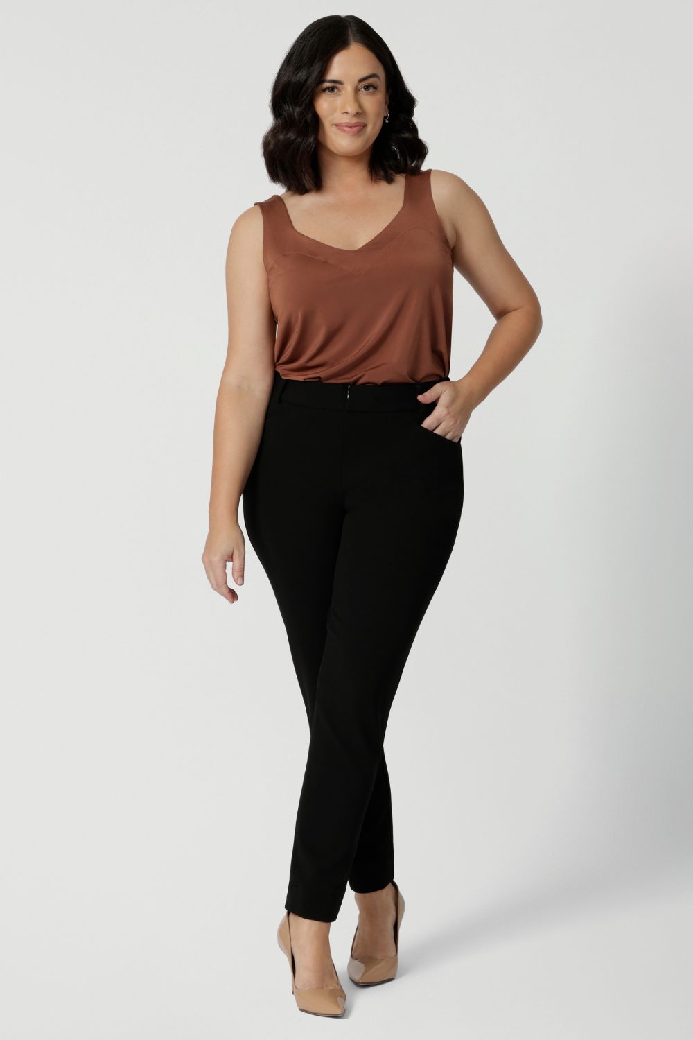 Petite height model wears black cropped pants. The Corbin Pants are perfect workwear pants made of Black Scuba Crepe. This off duty pant style is breathable and stretchy.  Australian made for Australian and New Zealand women. Leina & Fleur actively stock sizes 8-24 including plus & petite sizes. 